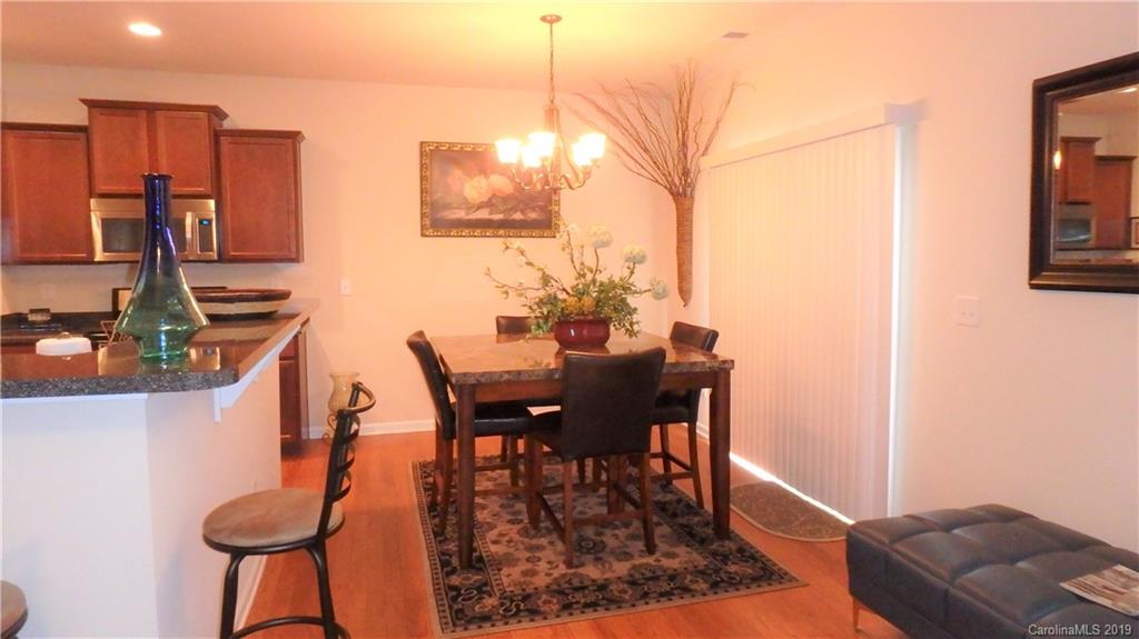 913 Rook Road Charlotte, NC 28216 - Photo 11 of 22 a view of a dining room with furniture and a chandelier