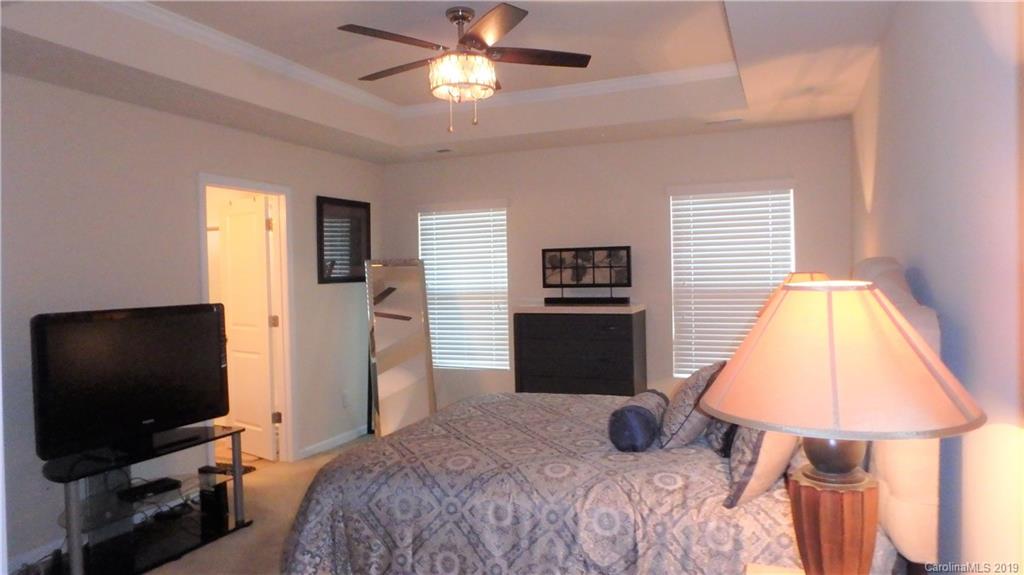913 Rook Road Charlotte, NC 28216 - Photo 13 of 22 a bedroom with a bed and a flat screen tv