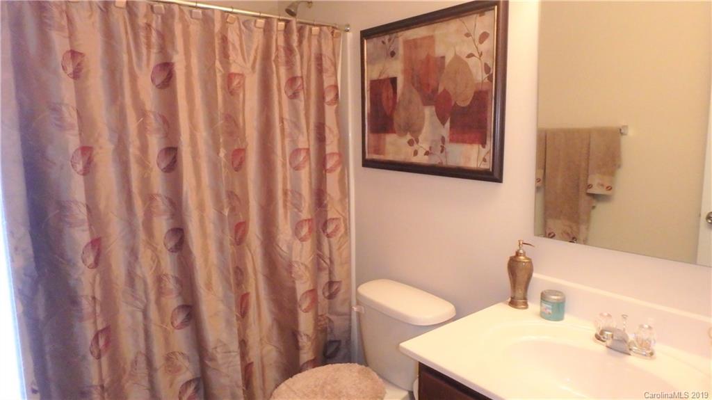 913 Rook Road Charlotte, NC 28216 - Photo 19 of 22 a bathroom with a sink and a mirror