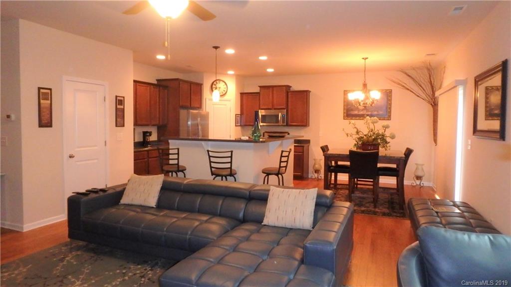 913 Rook Road Charlotte, NC 28216 - Photo 5 of 22 a living room with furniture and a dining table with kitchen view