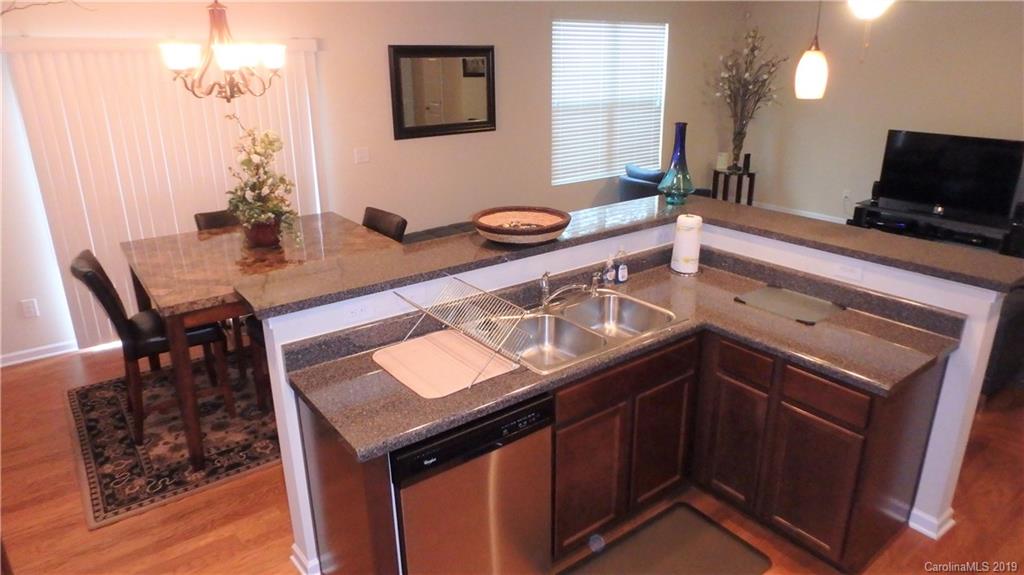 913 Rook Road Charlotte, NC 28216 - Photo 9 of 22 a kitchen with a sink cabinets and wooden floor