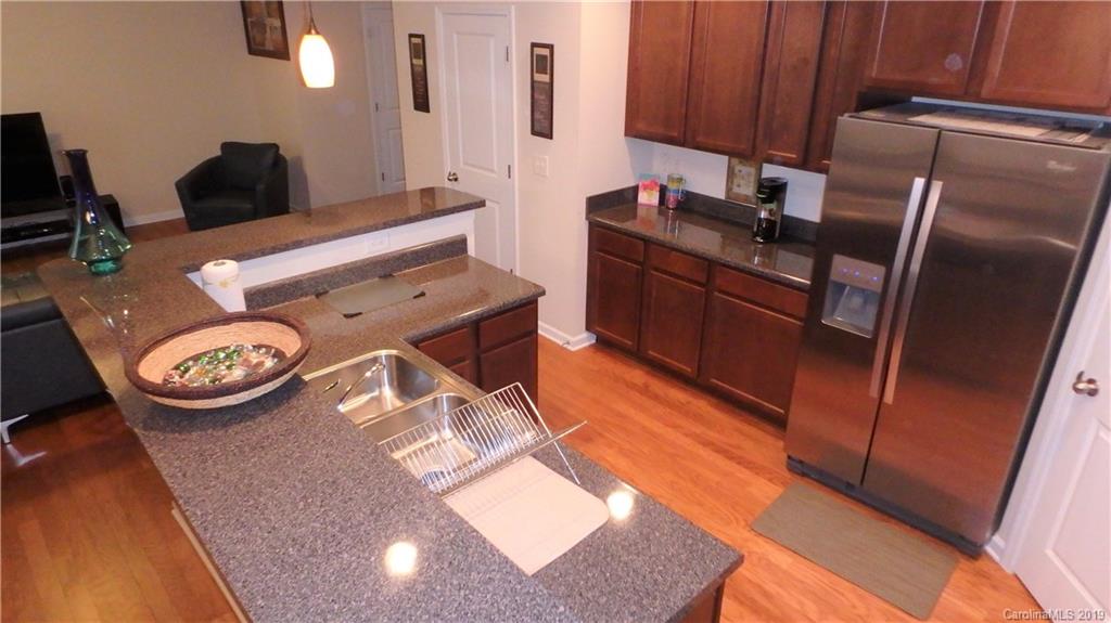 913 Rook Road Charlotte, NC 28216 - Photo 10 of 22 a kitchen with stainless steel appliances granite countertop a sink and a refrigerator