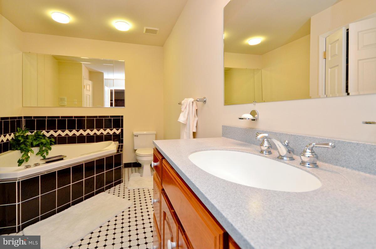 15615 Riding Stable Road Laurel, MD 20707 - Photo 14 of 30 a bathroom with a sink and a mirror