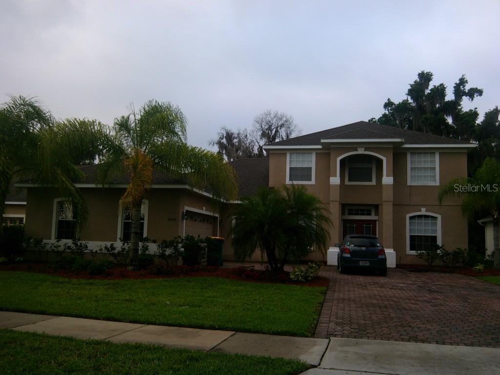 2250 Rambling Oaks Way Kissimmee, FL 34746 - Photo 1 of 1 a front view of house with a garden