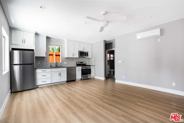 a kitchen with stainless steel appliances a refrigerator sink and stove