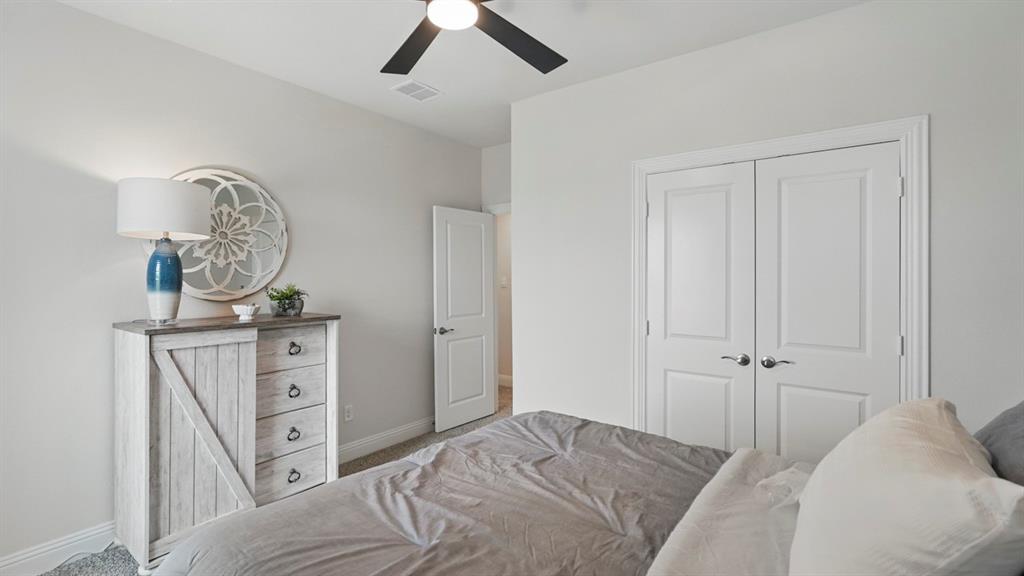 1016 Pitchfork Road Royse City, TX 75189 - Photo 27 of 35 a view of a bedroom with a bed and wooden floor