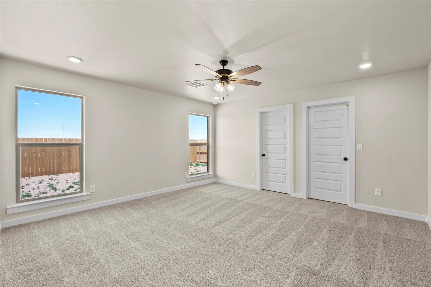 7446 29th Street Lubbock, TX 79407 - Photo 8 of 11 an empty room with fan and windows