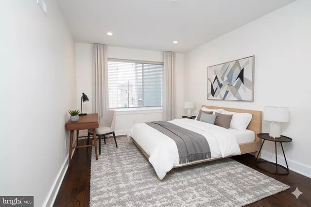 a bedroom with a large bed and a window