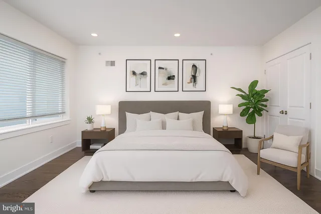 a bedroom with a large bed and a couch