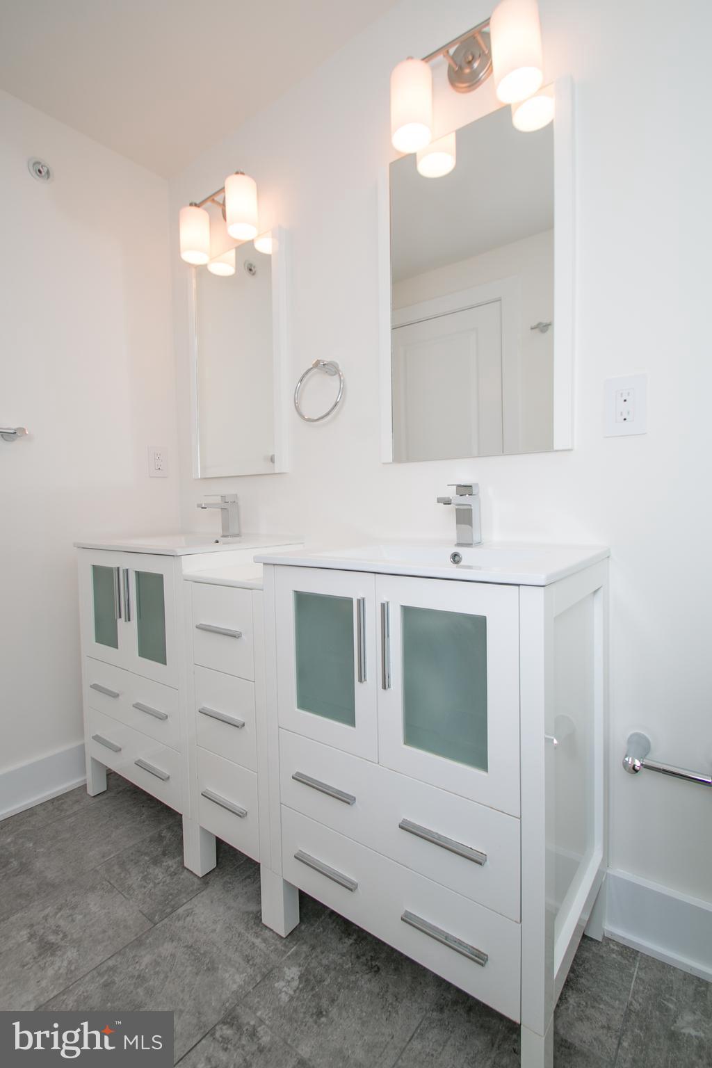 1022-24 South 2nd Street, Unit 4 Philadelphia, PA 19147 - Photo 28 of 50 a bathroom with a sink and a mirror