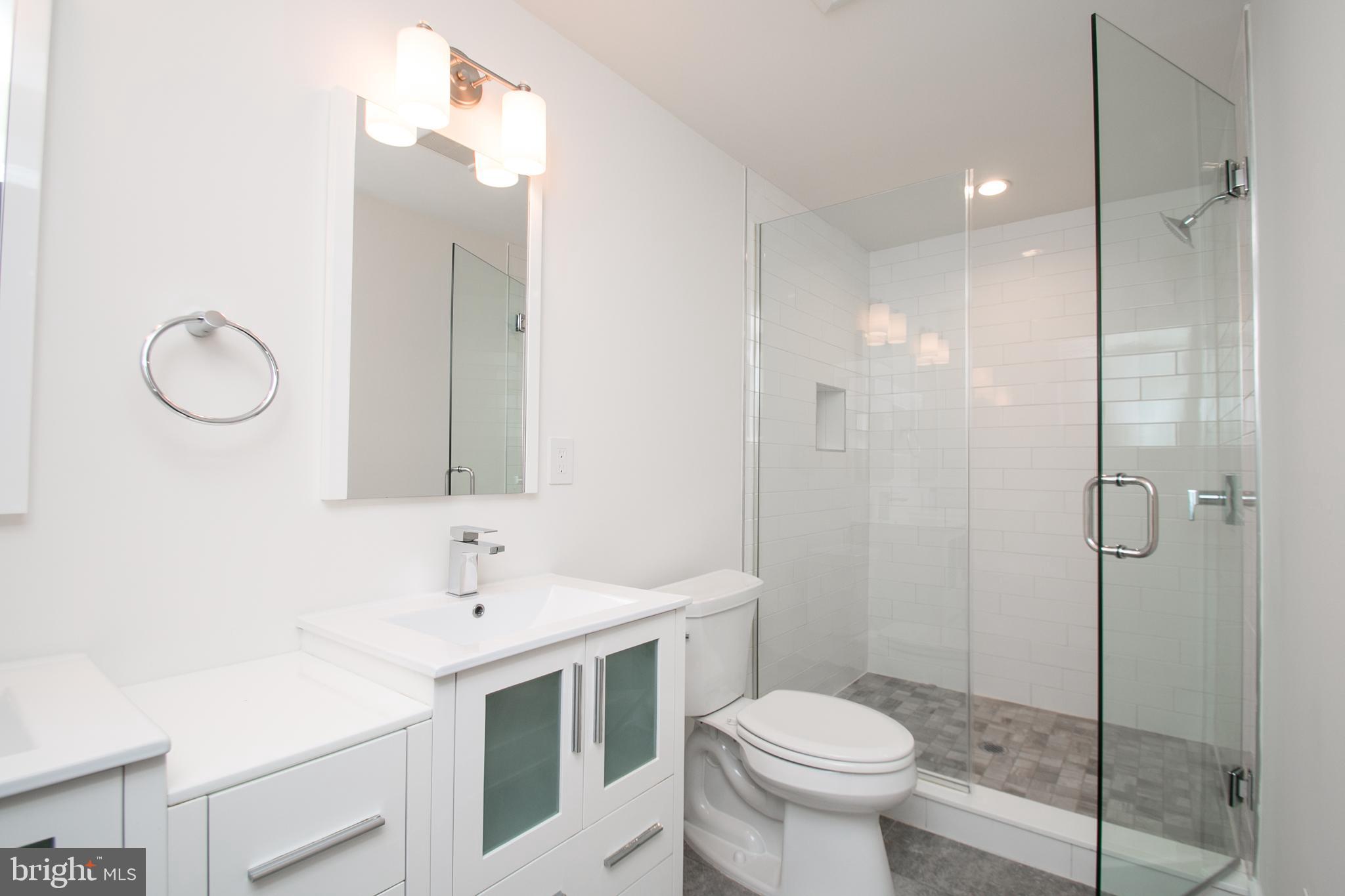 1022-24 South 2nd Street, Unit 4 Philadelphia, PA 19147 - Photo 29 of 50 a bathroom with a sink toilet and shower