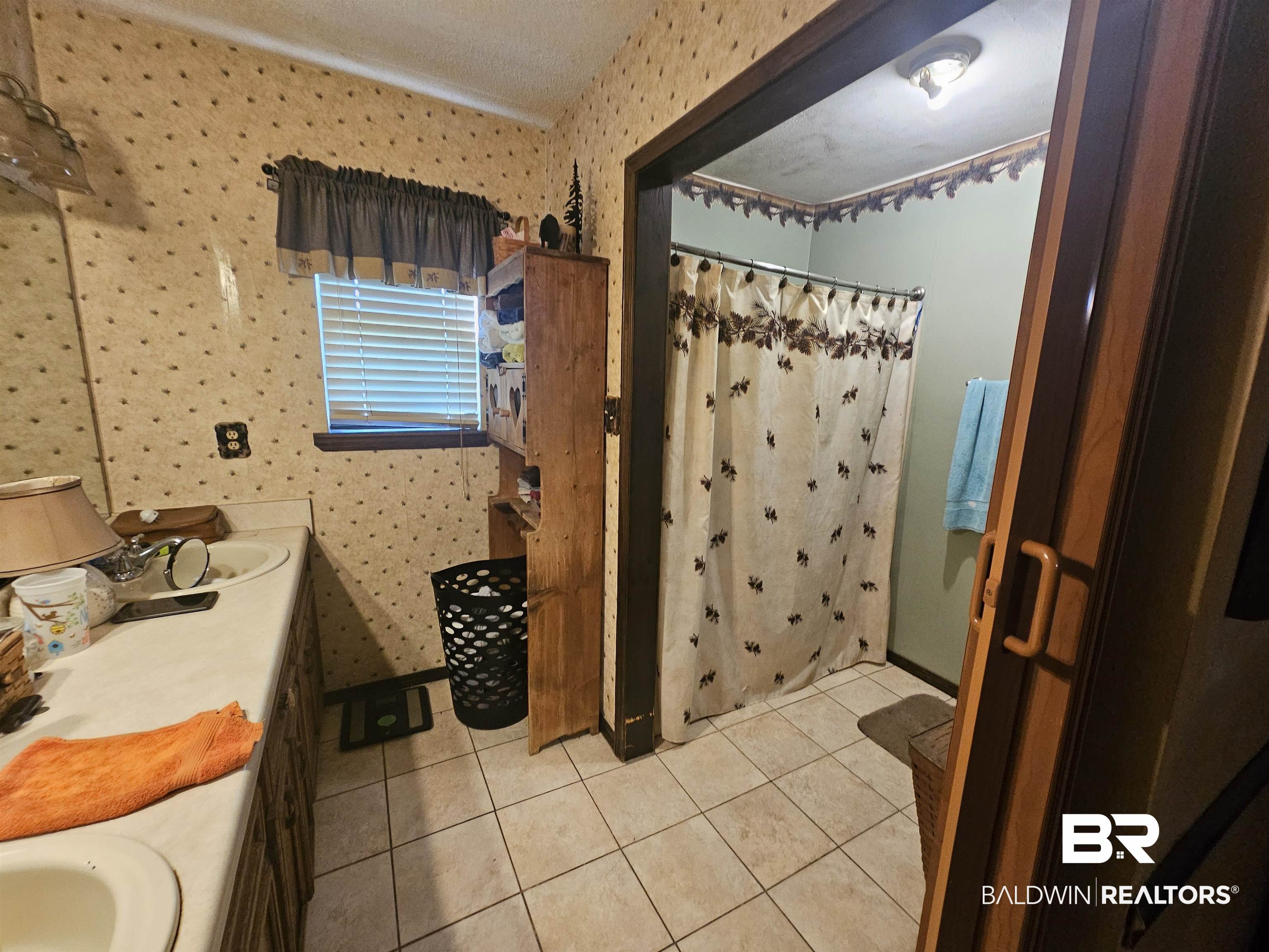 1818 Old Fannie Road Flomaton, AL 36441 - Photo 15 of 20 Full bathroom featuring tile patterned floors, curtained shower, vanity, and wallpapered walls