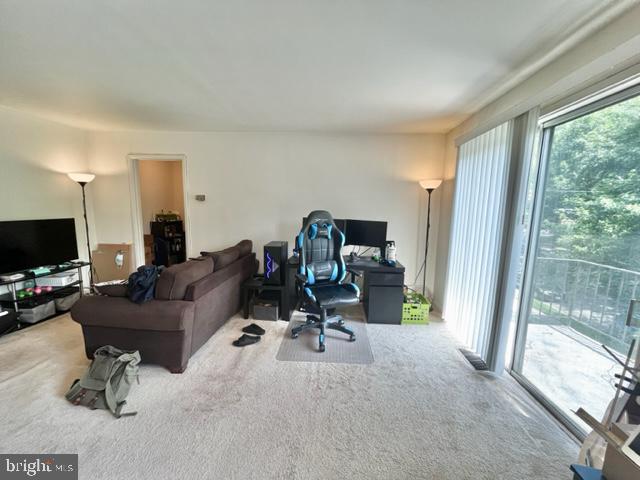 10618 Kenilworth Avenue, Unit 10618 Bethesda, MD 20814 - Photo 5 of 11 a view of a livingroom with workspace and a window