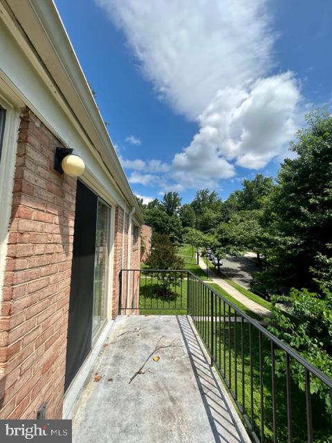 10618 Kenilworth Avenue, Unit 10618 Bethesda, MD 20814 - Photo 8 of 11 a view of a balcony with wooden floor and fence