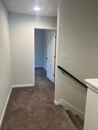 an empty room with closet and a bathroom