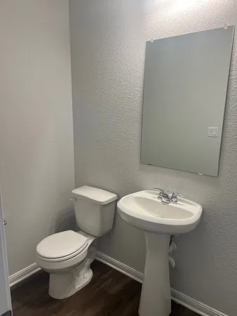 a bathroom with a sink a toilet and mirror