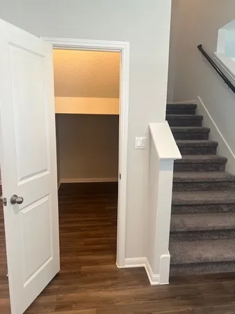 a view of entryway and hall with wooden floor