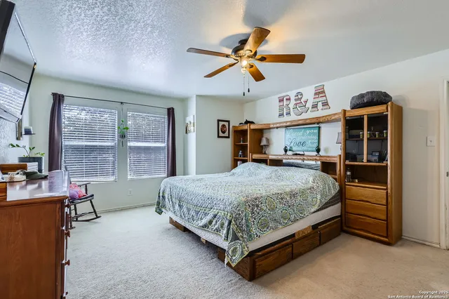 a bed room with a bed and a large window