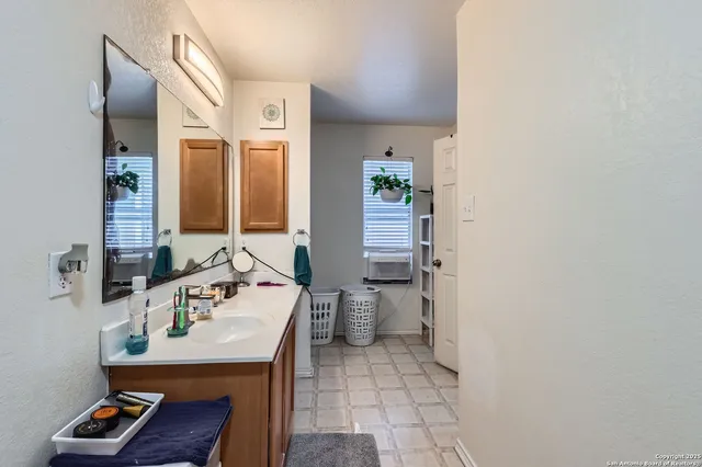 a bathroom with a sink mirror and toilet