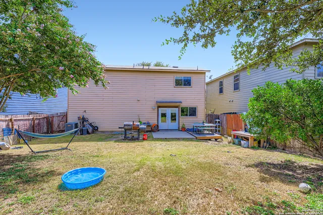 a view of a house with swimming pool and sitting area