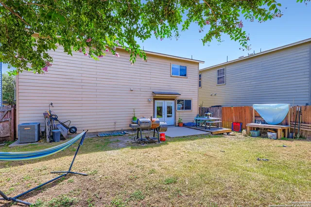 a view of a house with backyard porch and sitting area