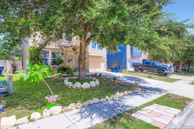 a front view of a house with garden