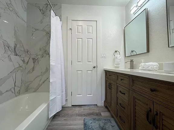 2502 Tracy Cove Leander, TX 78641 - Photo 16 of 34 a bathroom with a tub sink and mirror