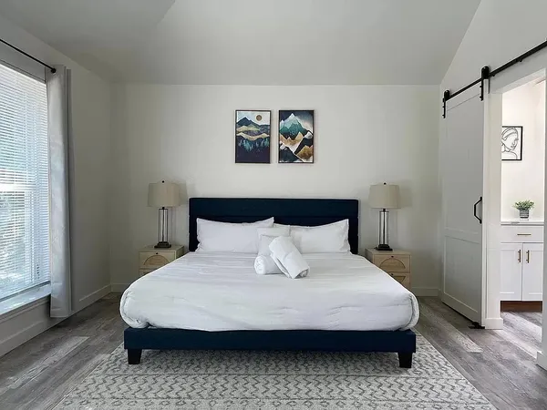 a bedroom with bed and window