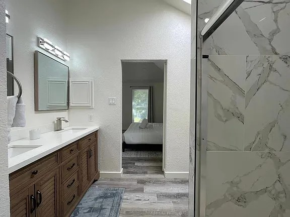 2502 Tracy Cove Leander, TX 78641 - Photo 23 of 34 a bathroom with a double vanity sink mirror and bathtub