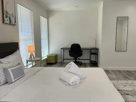 a bedroom with a bed and window