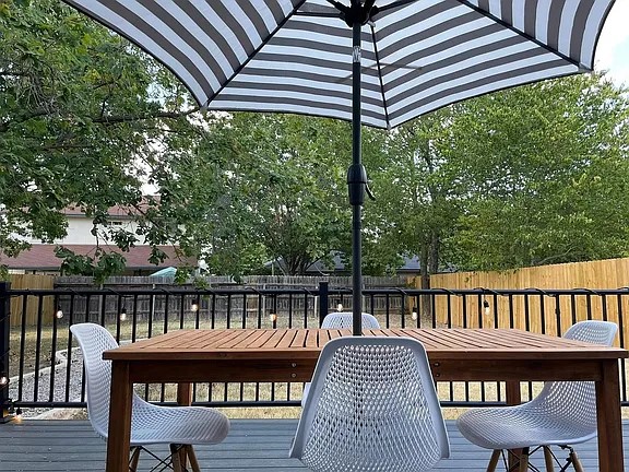 2502 Tracy Cove Leander, TX 78641 - Photo 32 of 34 Wooden terrace featuring outdoor dining area and a fenced backyard