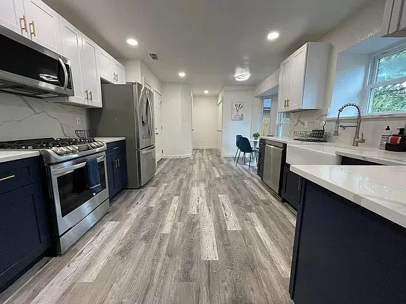 a kitchen with a sink cabinets and window