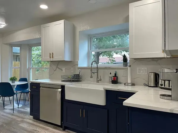 a kitchen with stainless steel appliances granite countertop a refrigerator and a stove