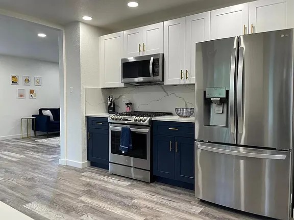 2502 Tracy Cove Leander, TX 78641 - Photo 10 of 34 a kitchen with stainless steel appliances granite countertop a refrigerator and a stove