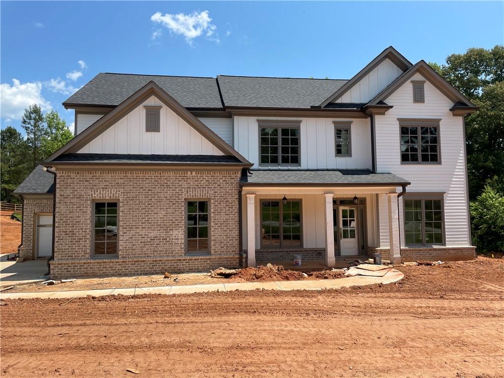 6390 Elmo Road Cumming, GA 30028 - Photo 1 of 1 a front view of a house with a yard