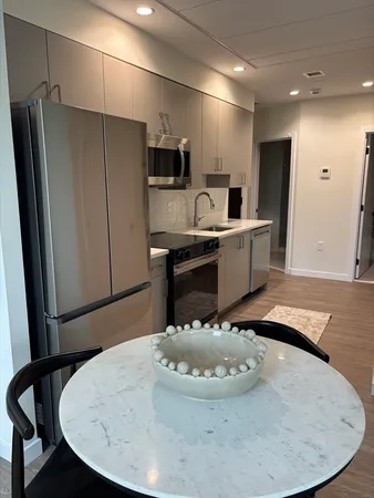 a large kitchen with a stove a refrigerator and a fireplace