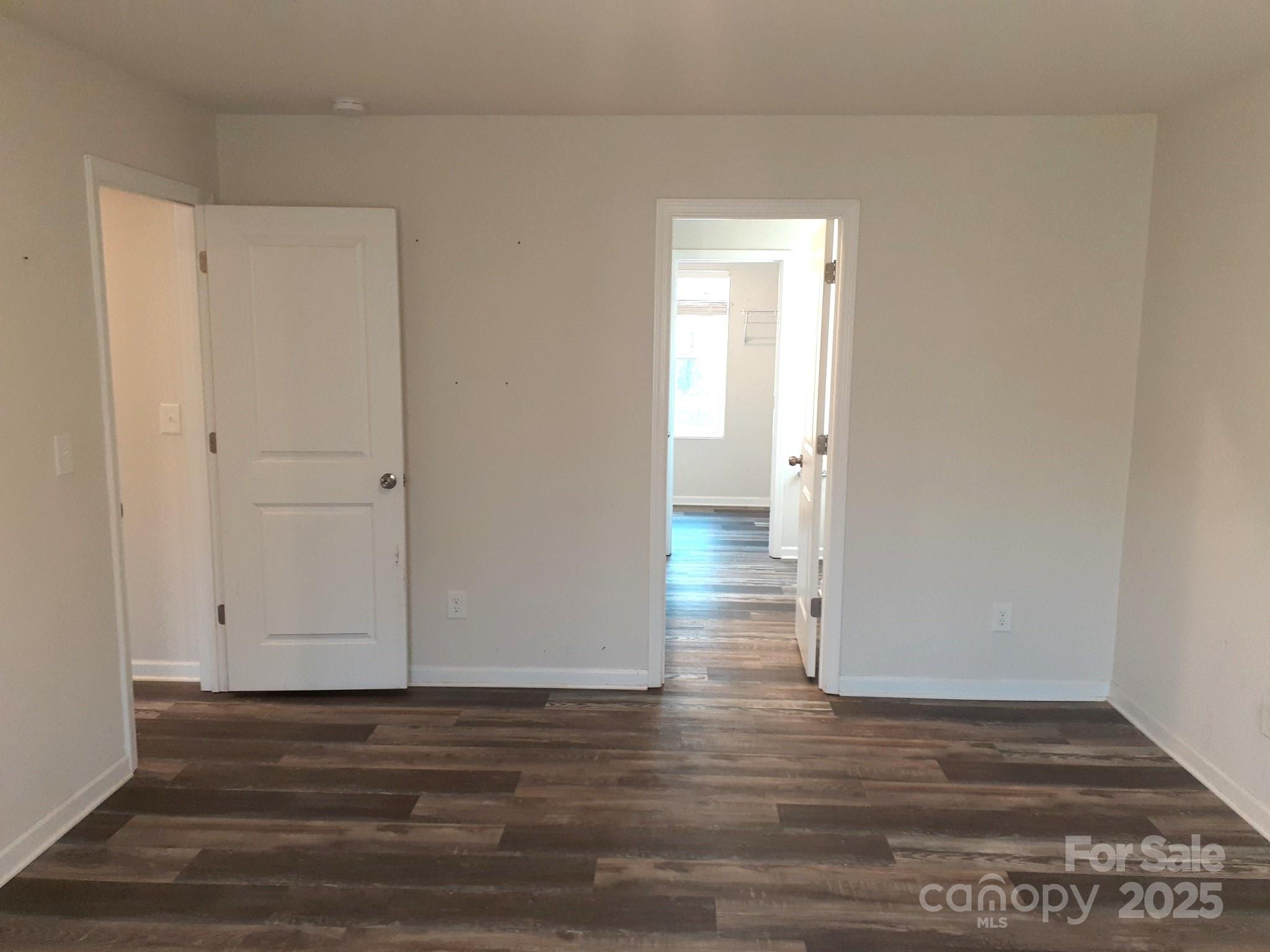 3944 Wade E Morgan Road Charlotte, NC 28269 - Photo 15 of 20 a view of an empty room with wooden floor and a window