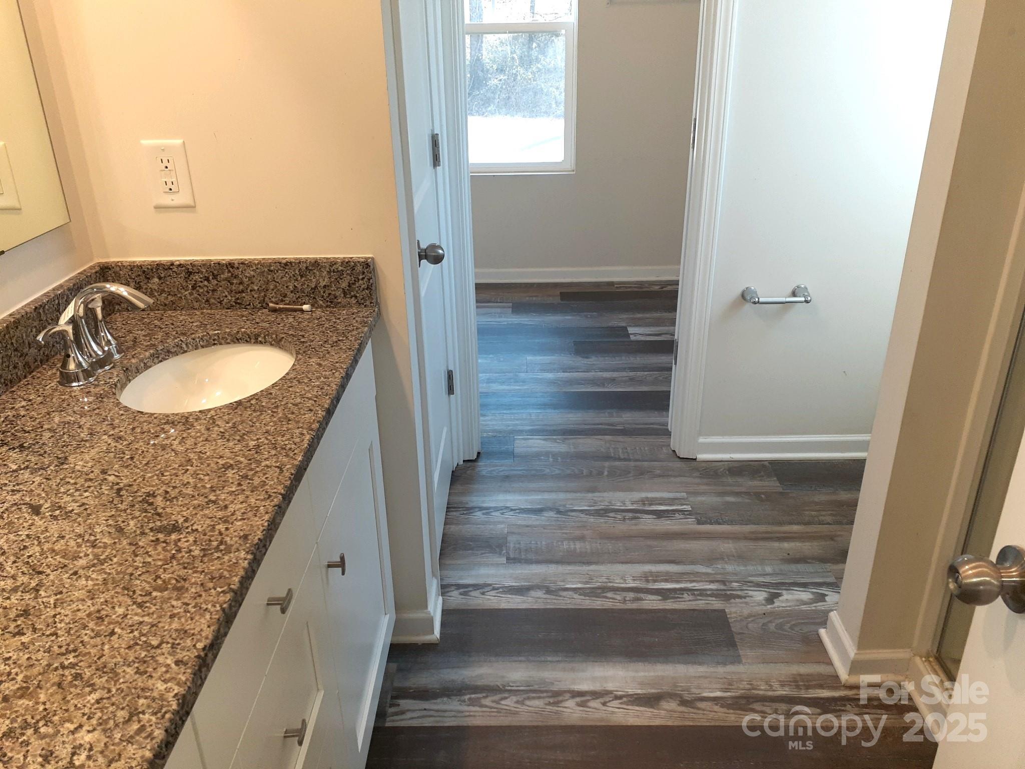 3944 Wade E Morgan Road Charlotte, NC 28269 - Photo 16 of 20 a bathroom with a sink and a mirror