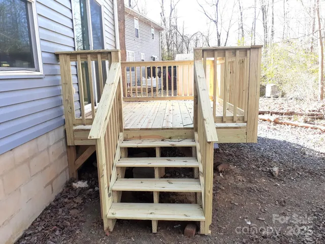 a view of a balcony with wooden floor and fence