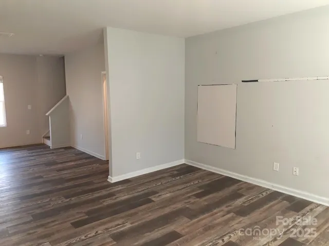 a view of a room with wooden floor
