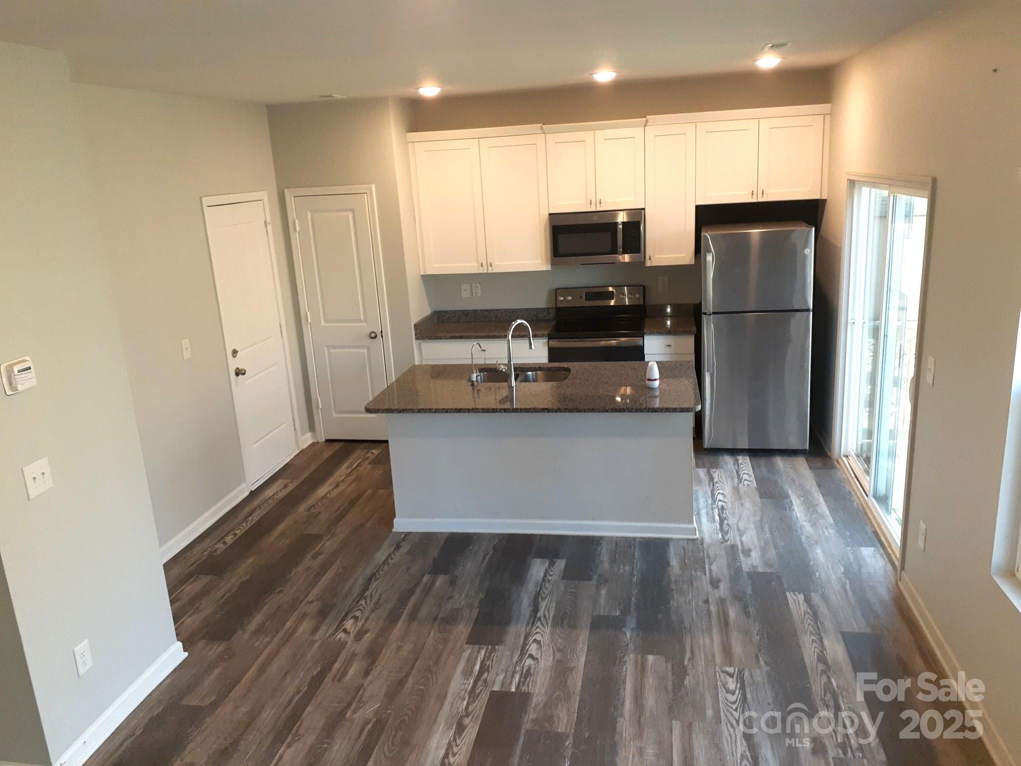 3944 Wade E Morgan Road Charlotte, NC 28269 - Photo 8 of 20 a kitchen with stainless steel appliances a refrigerator and a stove top oven