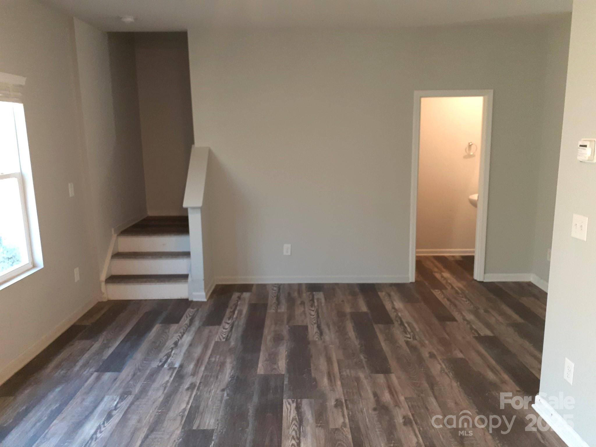 3944 Wade E Morgan Road Charlotte, NC 28269 - Photo 9 of 20 a view of wooden floor and windows in a room