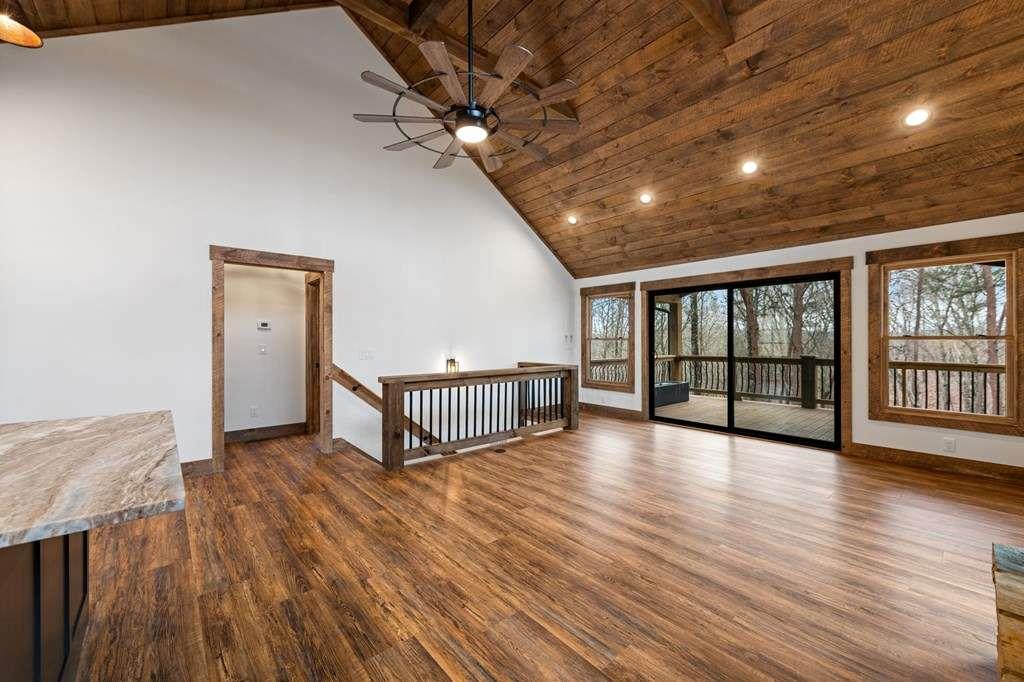 2393 Ada Street Blue Ridge, GA 30513 - Photo 11 of 56 a view of an empty room with wooden floor and a window