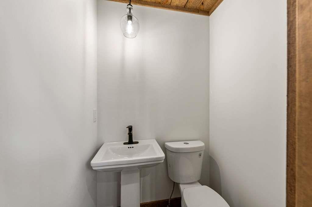2393 Ada Street Blue Ridge, GA 30513 - Photo 20 of 56 a bathroom with a toilet sink and mirror