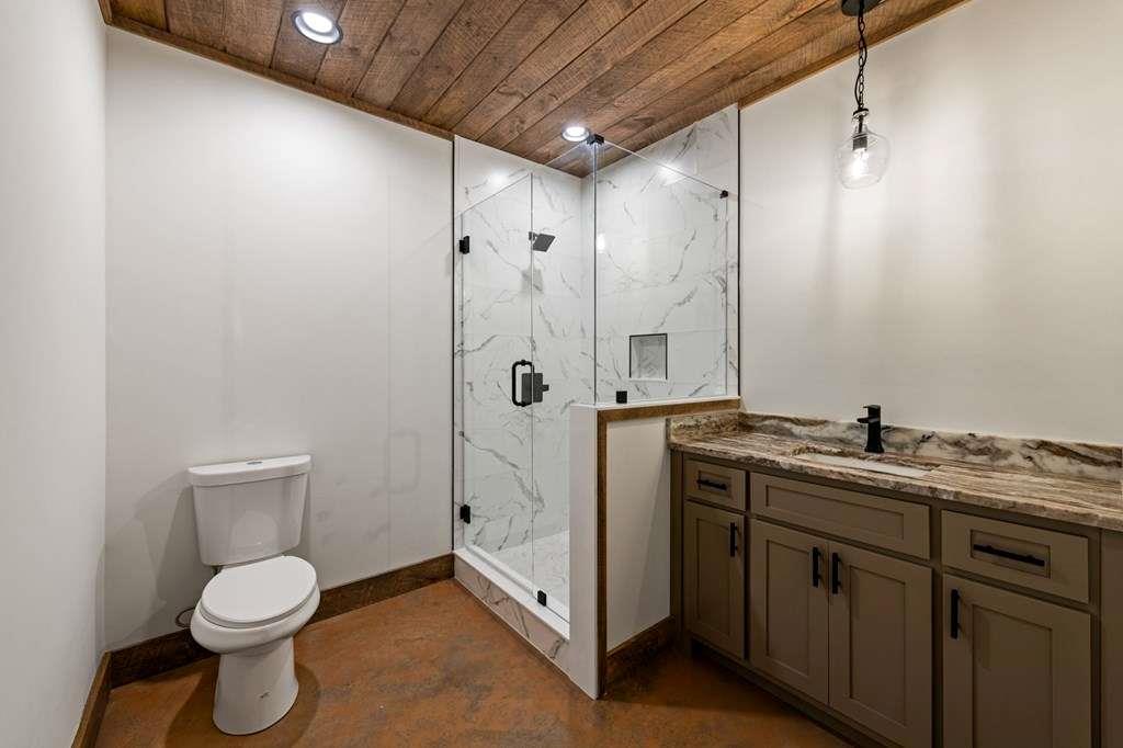 2393 Ada Street Blue Ridge, GA 30513 - Photo 38 of 56 a bathroom with a toilet sink and shower