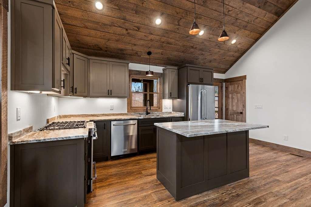 2393 Ada Street Blue Ridge, GA 30513 - Photo 7 of 56 a kitchen with stainless steel appliances granite countertop a sink stove and cabinets