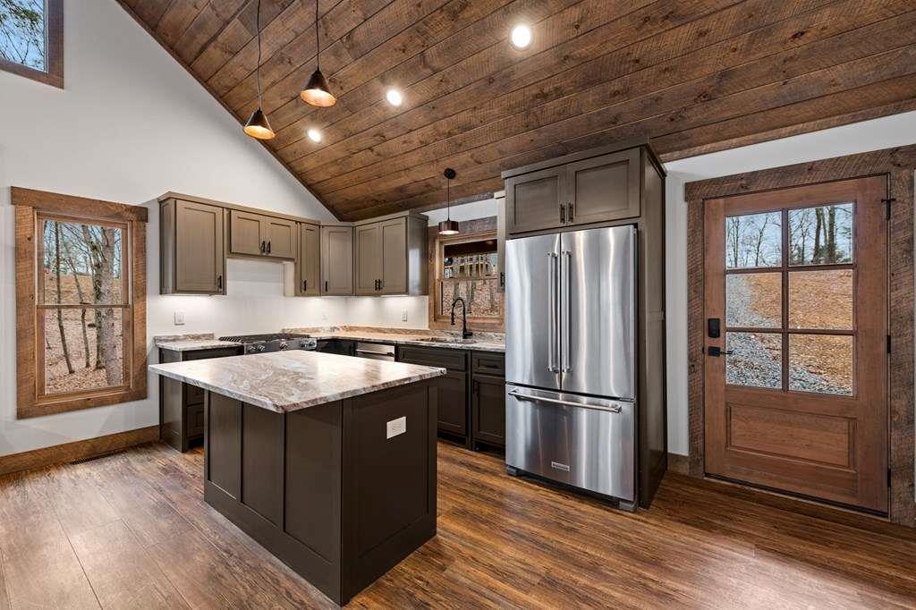 2393 Ada Street Blue Ridge, GA 30513 - Photo 8 of 56 a kitchen with stainless steel appliances granite countertop a stove a refrigerator and a sink