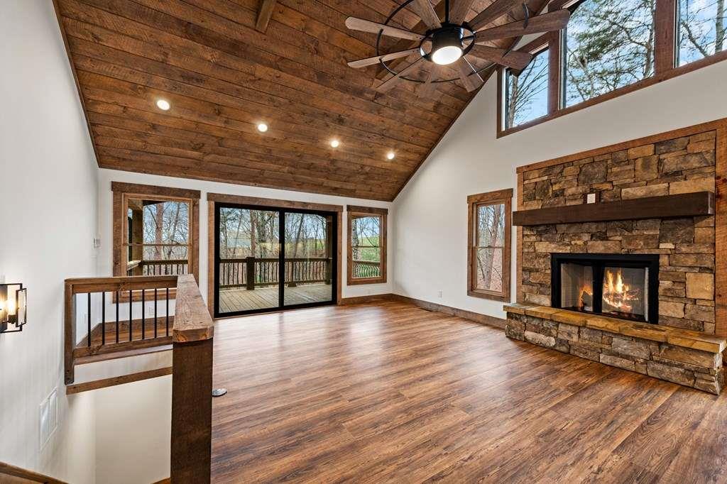 2393 Ada Street Blue Ridge, GA 30513 - Photo 10 of 56 a view of an empty room with wooden floor fireplace and a window