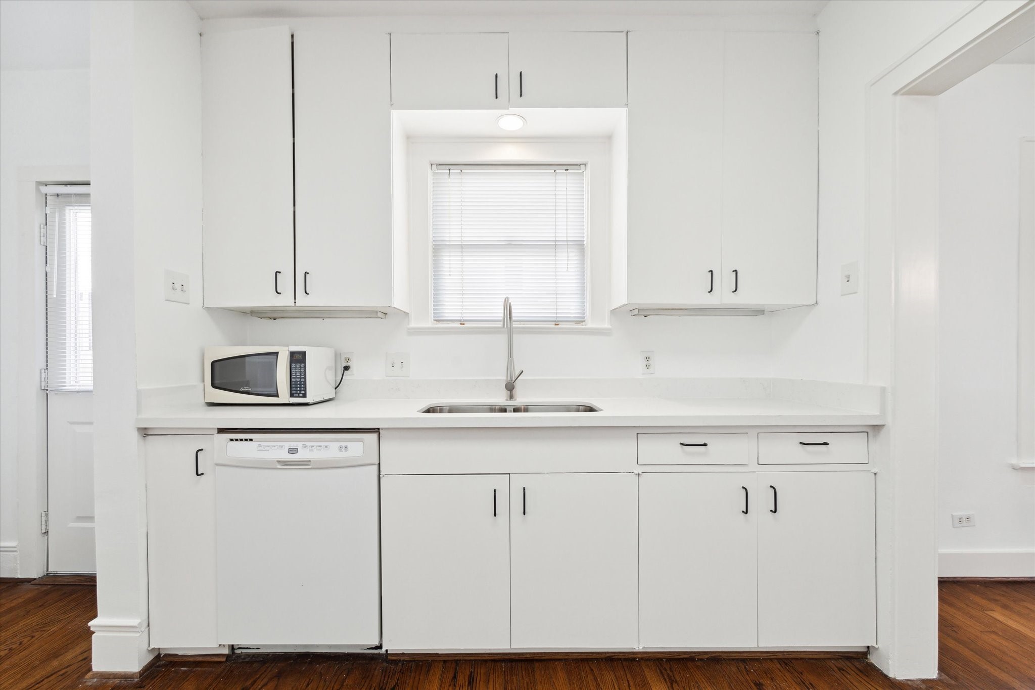 2309 Wroxton Road Houston, TX 77005 - Photo 11 of 15 a kitchen with white cabinets and sink