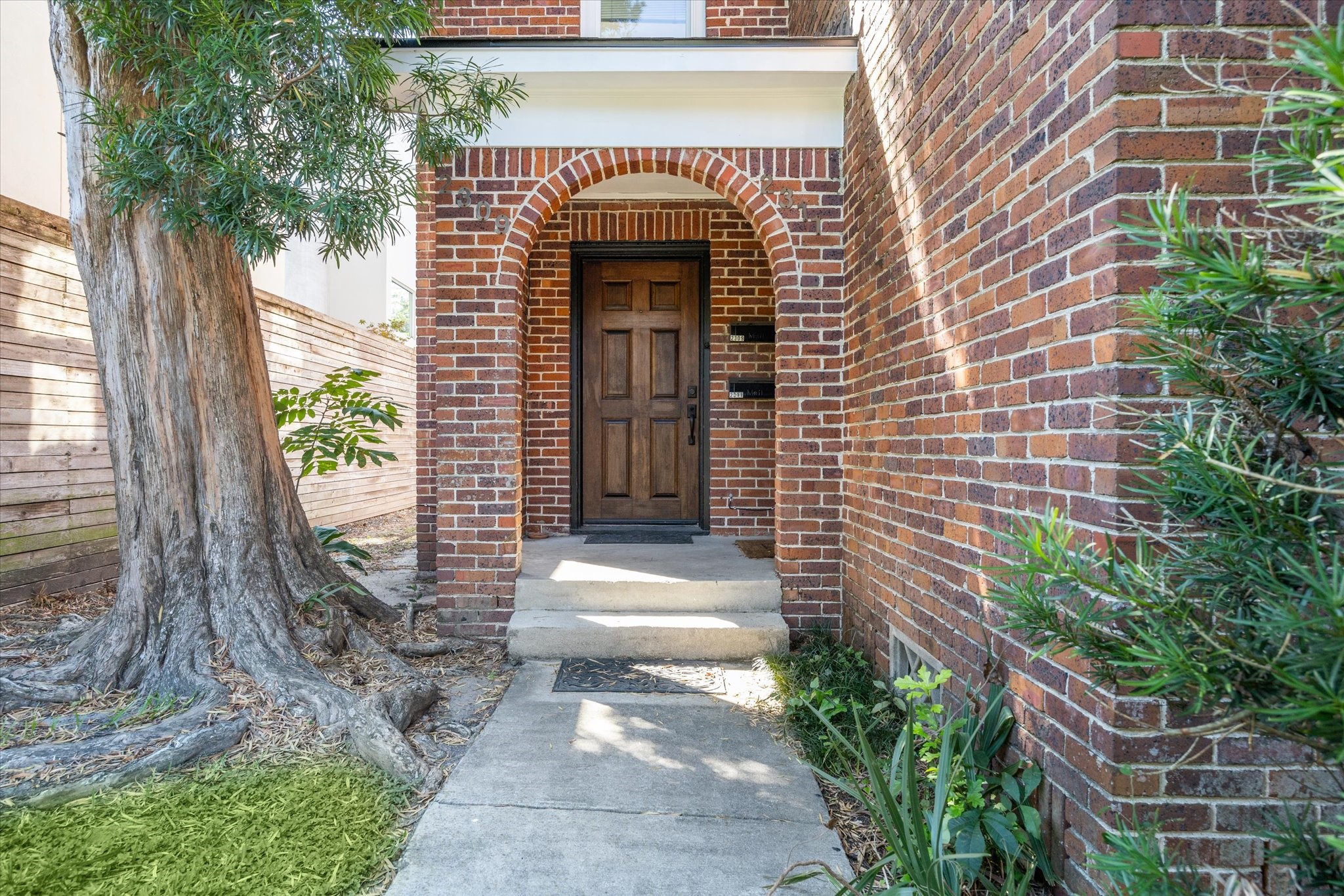 2309 Wroxton Road Houston, TX 77005 - Photo 2 of 15 a front view of a house with garden